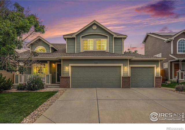 traditional-style house featuring an attached garage, a garage, brick siding, driveway, and roof with shingles