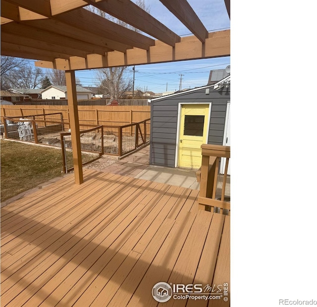 wooden deck featuring a pergola and fence