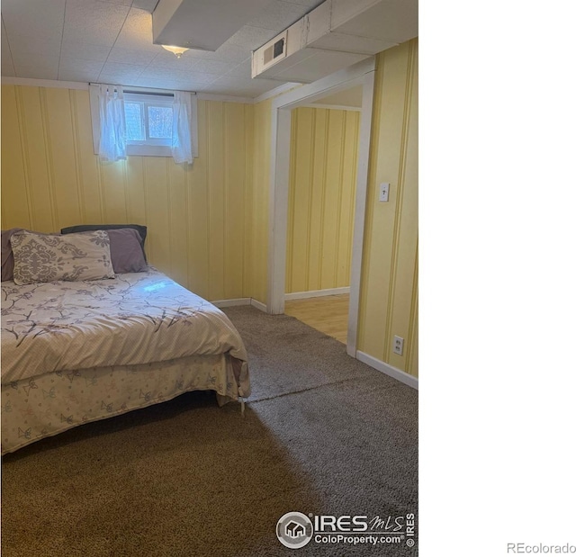 carpeted bedroom featuring visible vents and baseboards