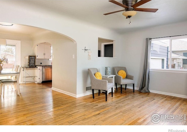 410 Cottonwood Ave, Eaton, CO 80615 - sitting room with light wood finished floors, ceiling fan, arched walkways, and baseboards