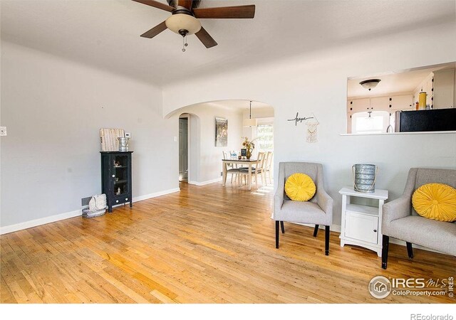 410 Cottonwood Ave, Eaton, CO 80615 - living area featuring arched walkways, ceiling fan, plenty of natural light, and light wood-type flooring