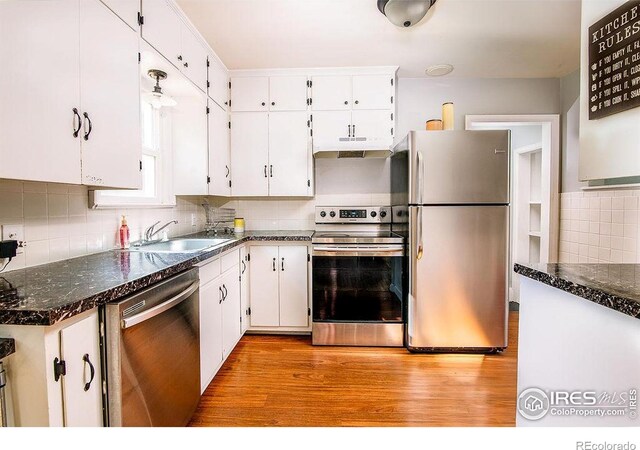 410 Cottonwood Ave, Eaton, CO 80615 - kitchen with stainless steel appliances, a sink, white cabinetry, and backsplash