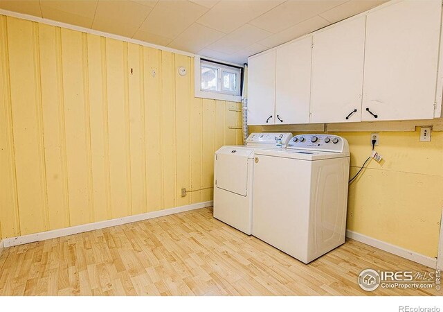 410 Cottonwood Ave, Eaton, CO 80615 - laundry area featuring cabinet space, light wood-style floors, washer and dryer, baseboards, and wooden walls