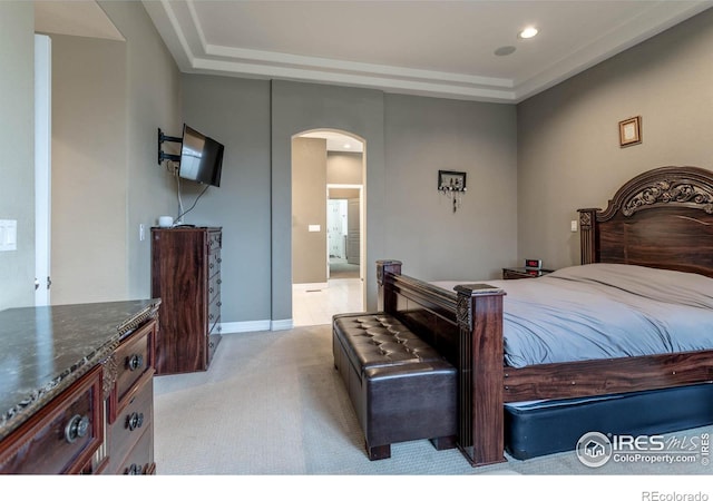 bedroom featuring arched walkways, light colored carpet, and recessed lighting