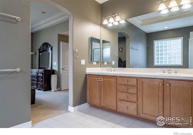 full bath with tile patterned floors, a sink, baseboards, and double vanity