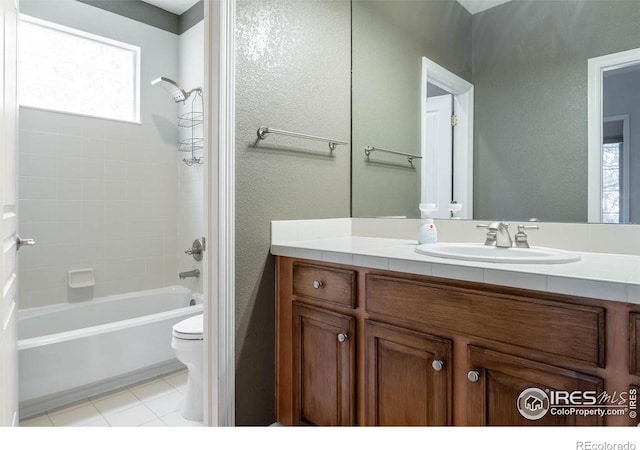 full bath featuring shower / bathtub combination, a textured wall, toilet, vanity, and tile patterned floors