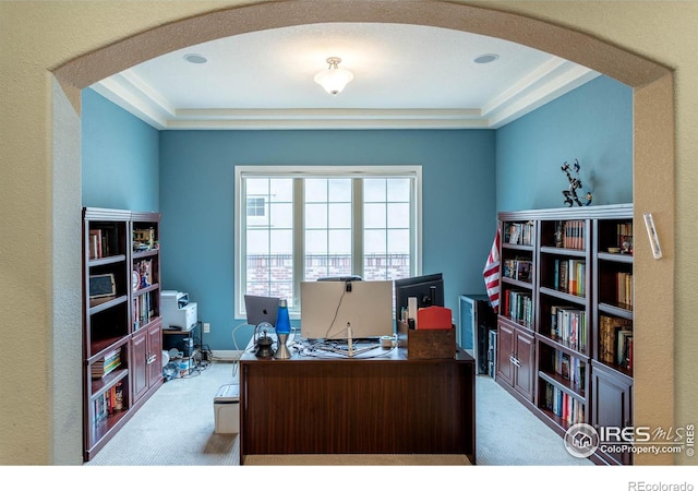 office space with arched walkways and carpet flooring