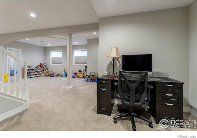 home office with recessed lighting, arched walkways, baseboards, and light colored carpet