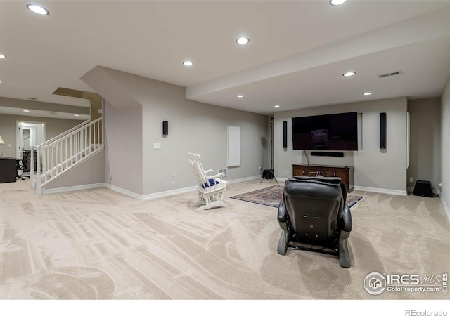 carpeted living room with baseboards, visible vents, stairway, and recessed lighting