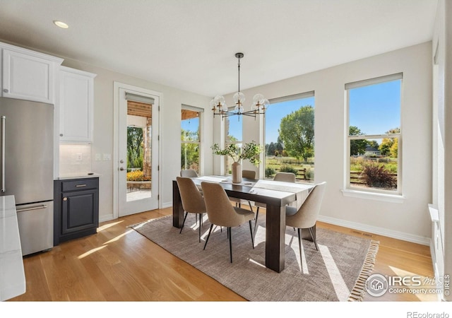 dining room with baseboards, visible vents, an inviting chandelier, recessed lighting, and light wood-type flooring