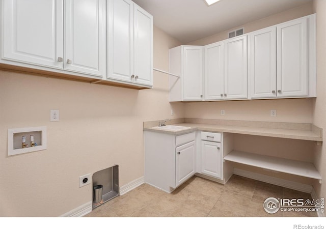 laundry room featuring hookup for a washing machine, baseboards, visible vents, cabinet space, and a sink