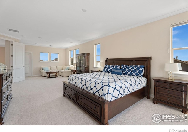 bedroom with carpet, visible vents, and ornamental molding