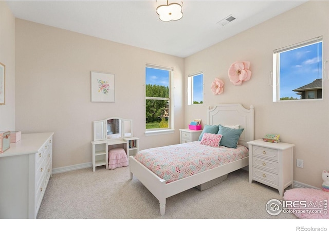 bedroom featuring visible vents, light carpet, and baseboards