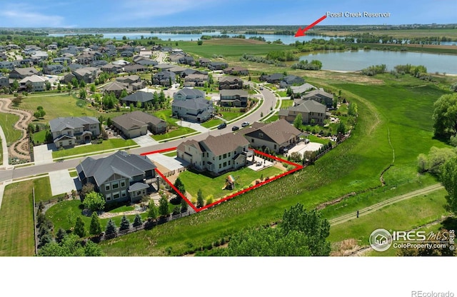 birds eye view of property with a residential view and a water view