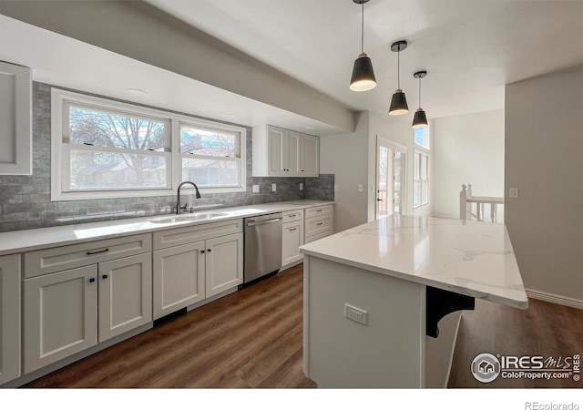 kitchen with a sink, dark wood finished floors, decorative backsplash, and dishwasher