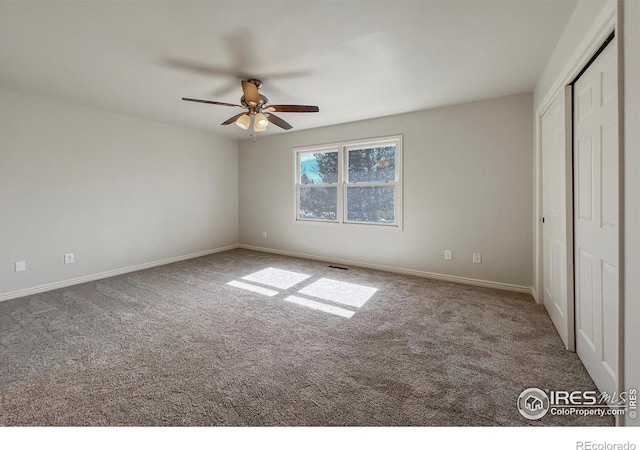 unfurnished bedroom with a ceiling fan, a closet, baseboards, and carpet flooring