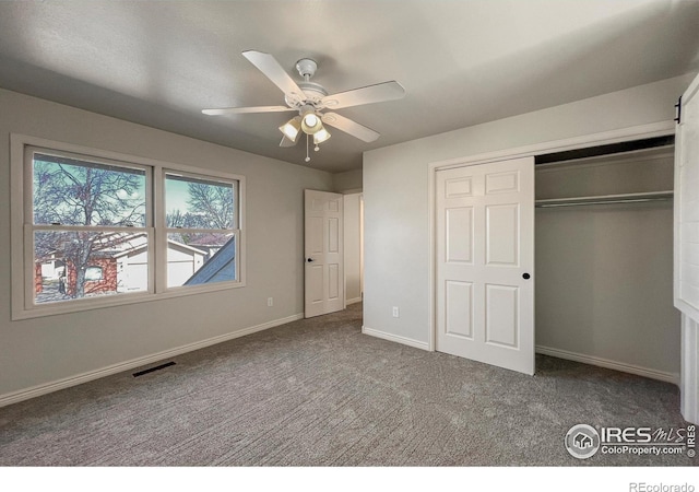 unfurnished bedroom featuring ceiling fan, carpet flooring, visible vents, baseboards, and a closet