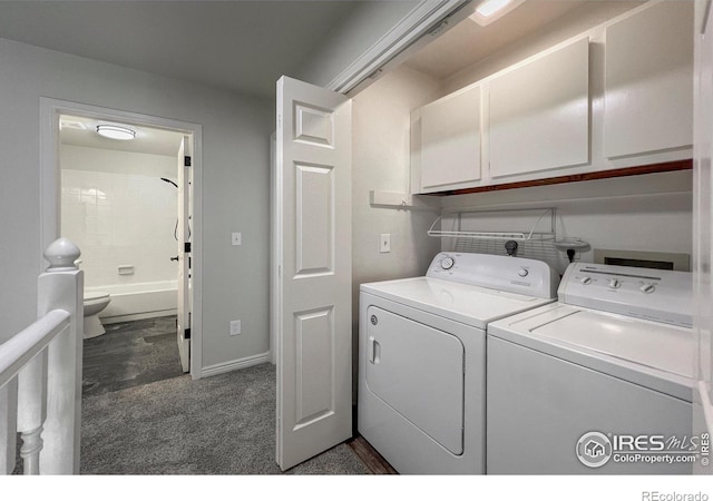 laundry area with washing machine and dryer, cabinet space, and dark carpet