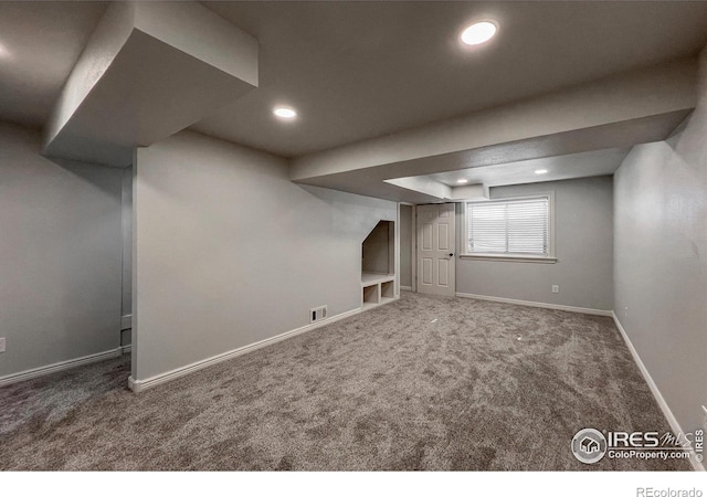 below grade area with recessed lighting, carpet flooring, visible vents, and baseboards