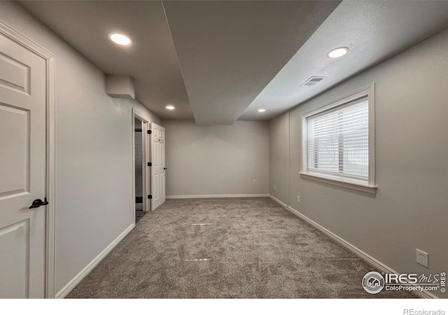 carpeted empty room with recessed lighting, visible vents, and baseboards