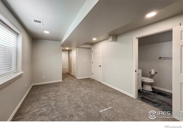 basement featuring carpet floors, recessed lighting, visible vents, and baseboards