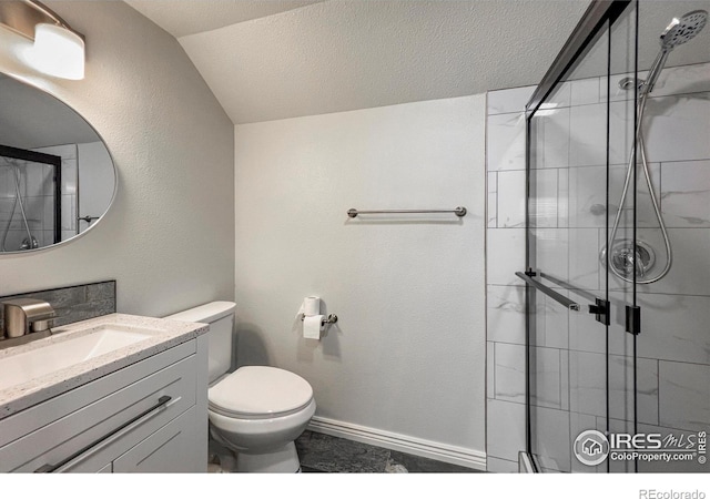 bathroom featuring a textured ceiling, toilet, vanity, vaulted ceiling, and a shower stall