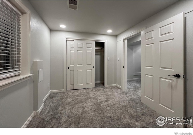 interior space featuring baseboards, visible vents, carpet flooring, a closet, and recessed lighting