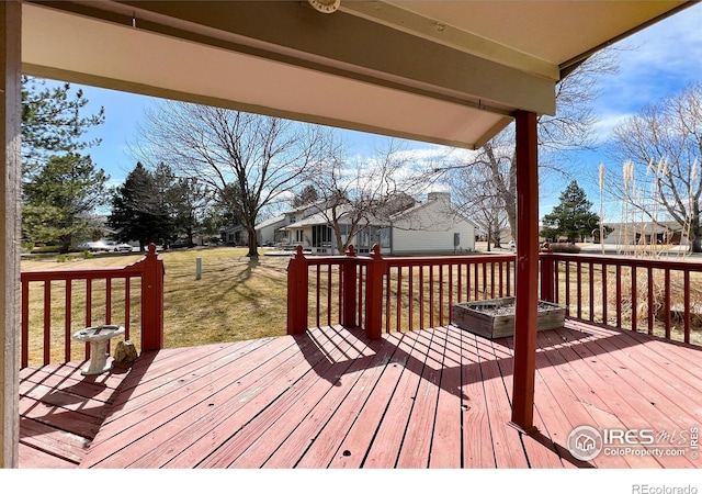 wooden terrace with a yard