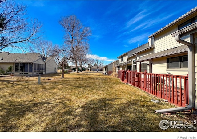 view of yard with a residential view and a sunroom