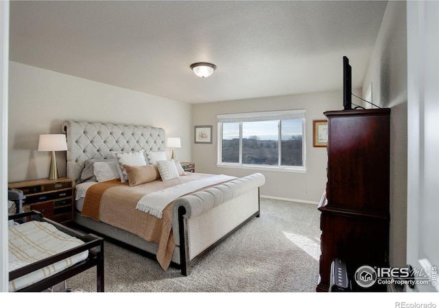 carpeted bedroom featuring baseboards