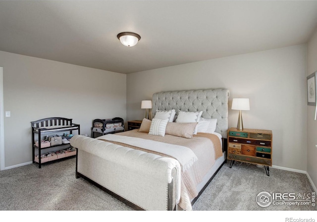 carpeted bedroom featuring baseboards