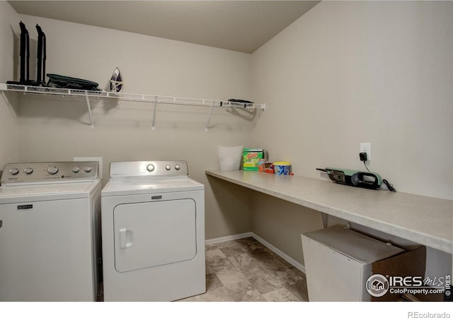 laundry area featuring laundry area, independent washer and dryer, and baseboards