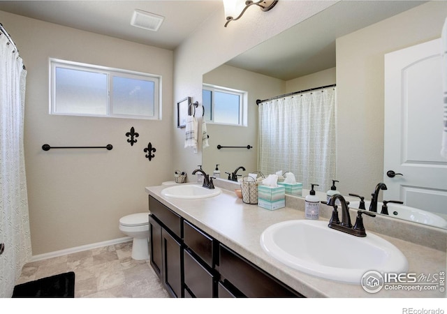 full bathroom featuring toilet, baseboards, and a sink