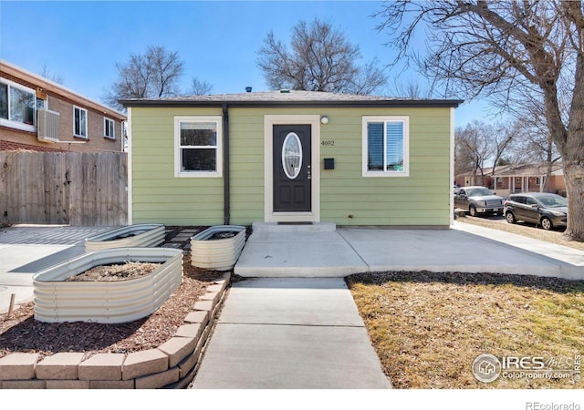 bungalow-style house with fence