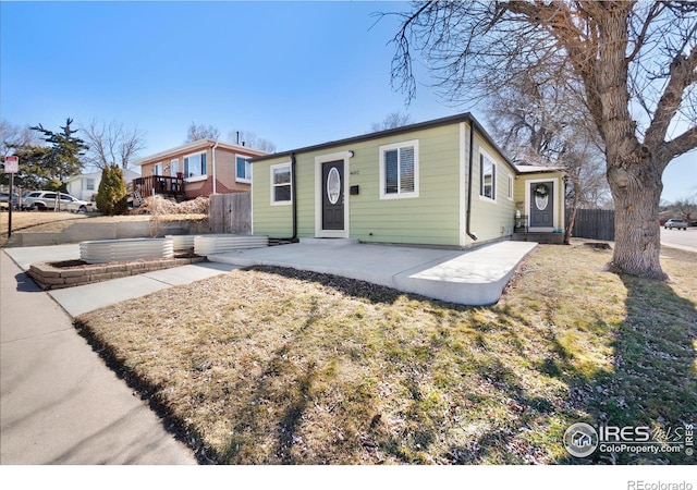 bungalow-style house featuring a patio area and fence