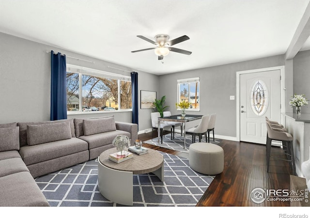 living area with ceiling fan, baseboards, and wood finished floors