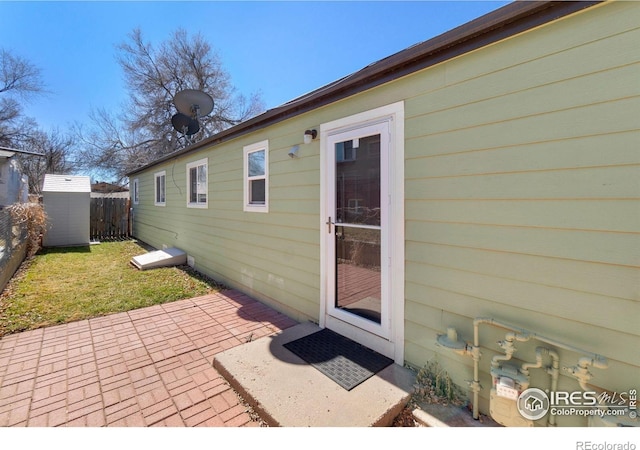 property entrance with a patio and fence