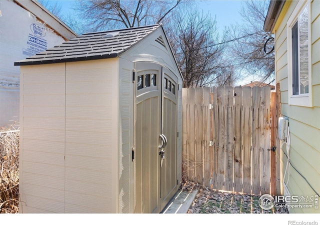 view of shed with fence