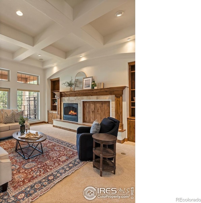 living area featuring beam ceiling, coffered ceiling, recessed lighting, a fireplace, and carpet flooring