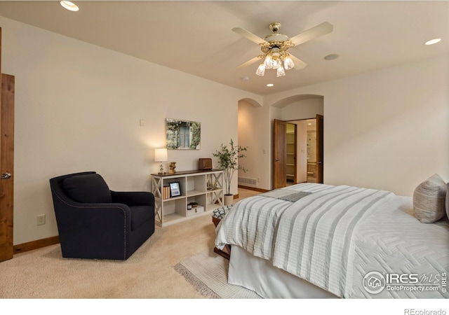 bedroom with a ceiling fan, carpet, baseboards, recessed lighting, and arched walkways