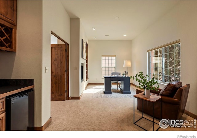 interior space featuring recessed lighting, baseboards, carpet, and a bar