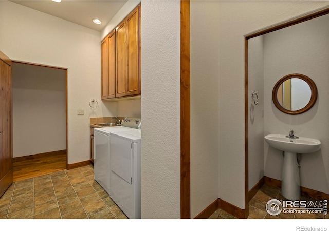 washroom with baseboards, recessed lighting, cabinet space, stone finish flooring, and independent washer and dryer