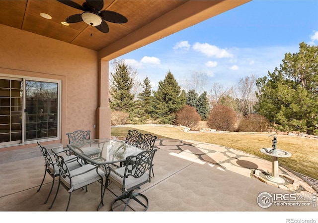 view of patio with outdoor dining space and a ceiling fan