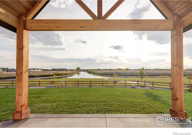 view of yard with a water view, a rural view, and fence