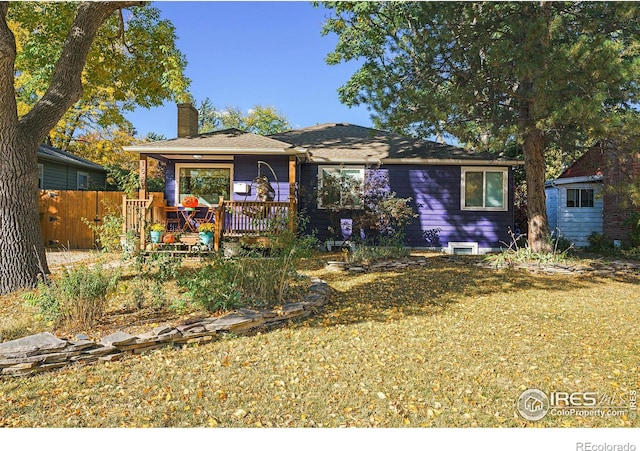 bungalow with a chimney and fence