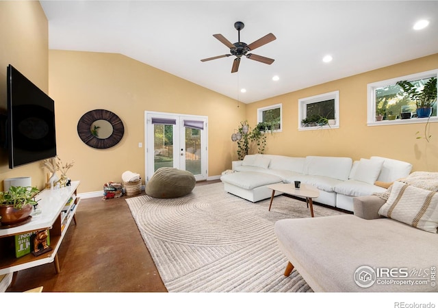 living room with lofted ceiling, recessed lighting, french doors, and concrete floors