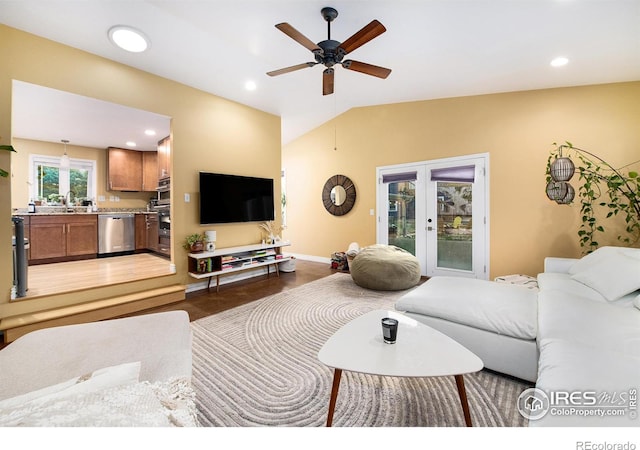 living area with lofted ceiling, recessed lighting, french doors, and ceiling fan