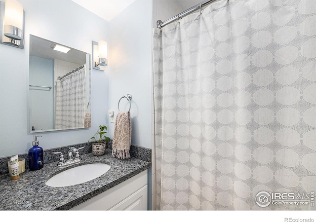 full bath with vanity and a shower with shower curtain