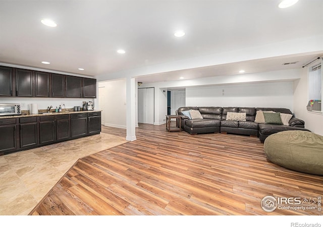 living area featuring visible vents, a toaster, recessed lighting, and light wood-type flooring