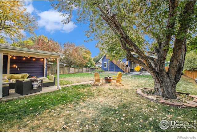 view of yard with a patio area, an outdoor living space with a fire pit, and a fenced backyard